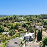 Stunning aerial view of a luxurious residential neighborhood surrounded by greenery.
